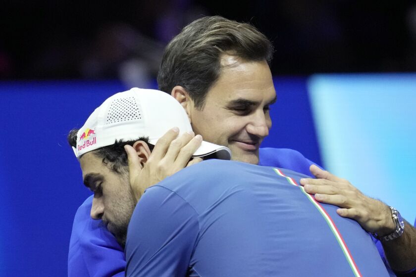 Team Europe's Matteo Berrettini, of Italy, celebrates with Roger Federer of Switzerland, after winning a match against Team World's Felix Auger-Aliassime, of Canada, on second day of the Laver Cup tennis tournament at the O2 in London, Saturday, Sept. 24, 2022. (AP Photo/Kin Cheung)