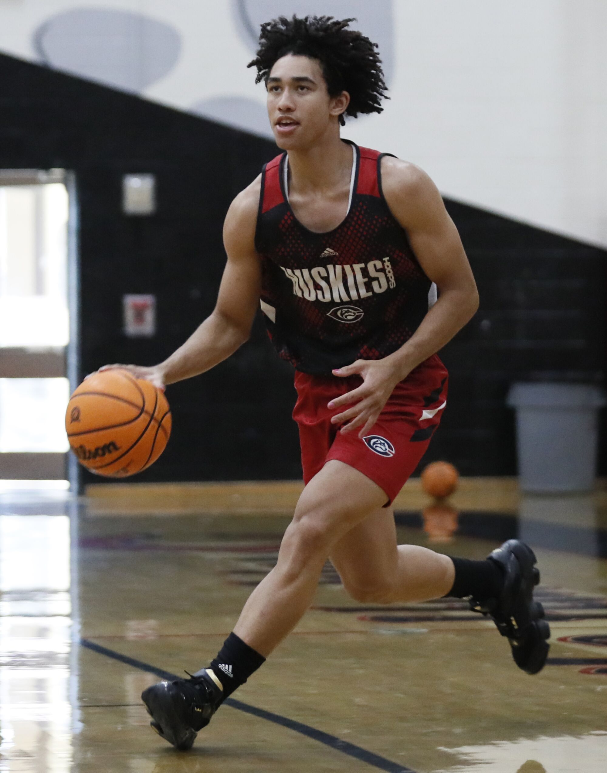 Centennial High guard Jared McCain dribbles the ball up court.