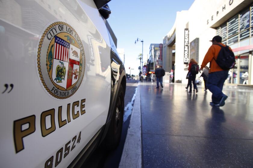 An LAPD cruiser parks at Hollywood and Highland on Jan. 7, near the scene of an early-morning incident in which authorities said a man stood on a sidewalk and began randomly firing into the air.