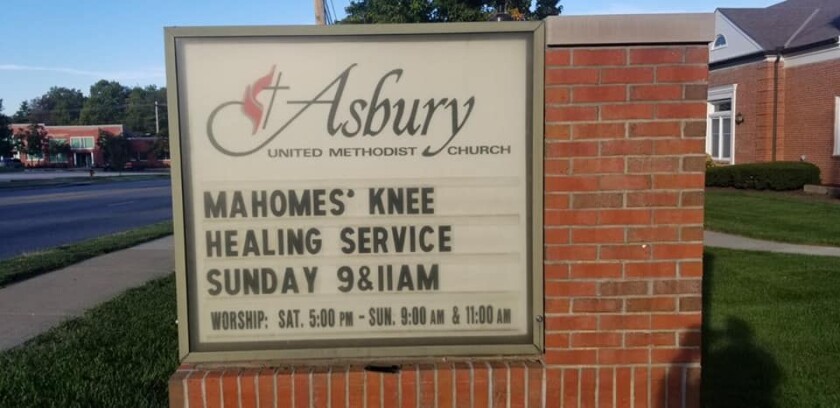 A sign for the Asbury United Methodist Church with a message advertising "Mahomes' knee healing service."