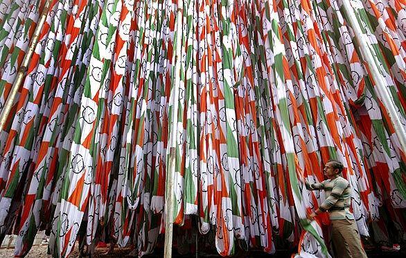 Flags supporting the candidacy of of Chiranjeevi, a single-named candidate in India's national elections, are prepared by a worker at a factory in Ahmadabad. Chiranjeevi was a popular actor in India before he entered politics.