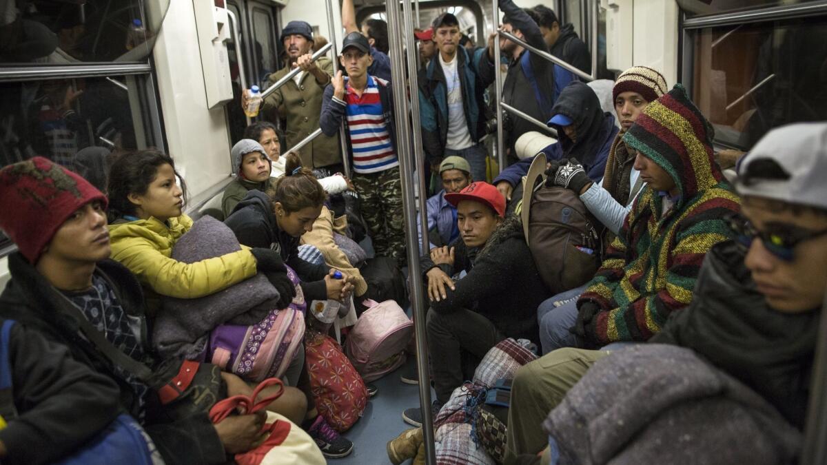 Central American migrants ride on the subway after leaving a temporary shelter at the Jesus Martinez Stadium in Mexico City on Friday. Most are headed north, some to Tijuana.