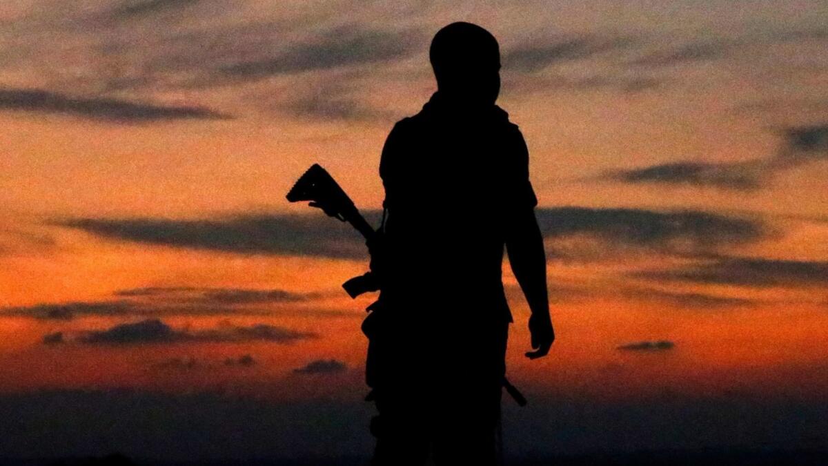 The silhouette of an Israeli soldier Tuesday in the southern Israeli town of Sderot.
