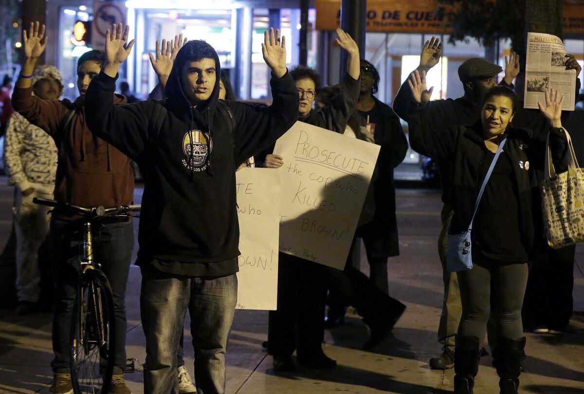 A group of people raise their arms while chanting "Hands Up, Don't Shoot" during a protest in San Francisco Monday after a grand jury decided not to indict Ferguson, Mo., police Officer Darren Wilson in the fatal shooting of Michael Brown, an unarmed black 18-year-old.