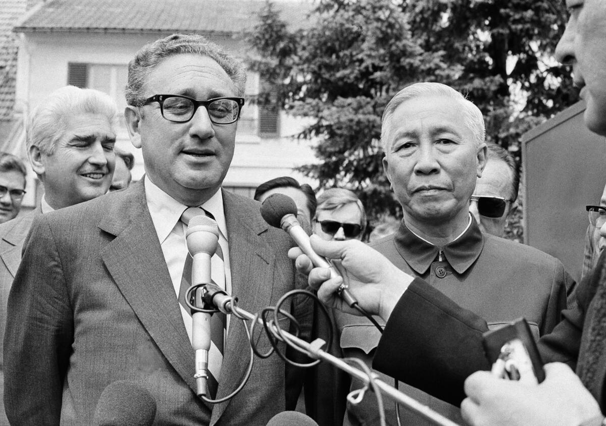 Henry A. Kissinger--then President Nixon's National Security Adviser--stands with Le Duc Tho, a member of Hanoi's Politburo, outside a suburban Paris house in June, 1973.