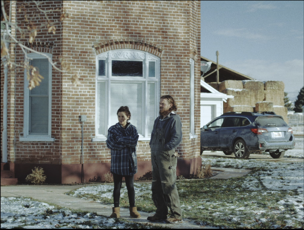 Niki (played by Sepideh Moafi) and David (Clayne Crawford) stand on a driveway