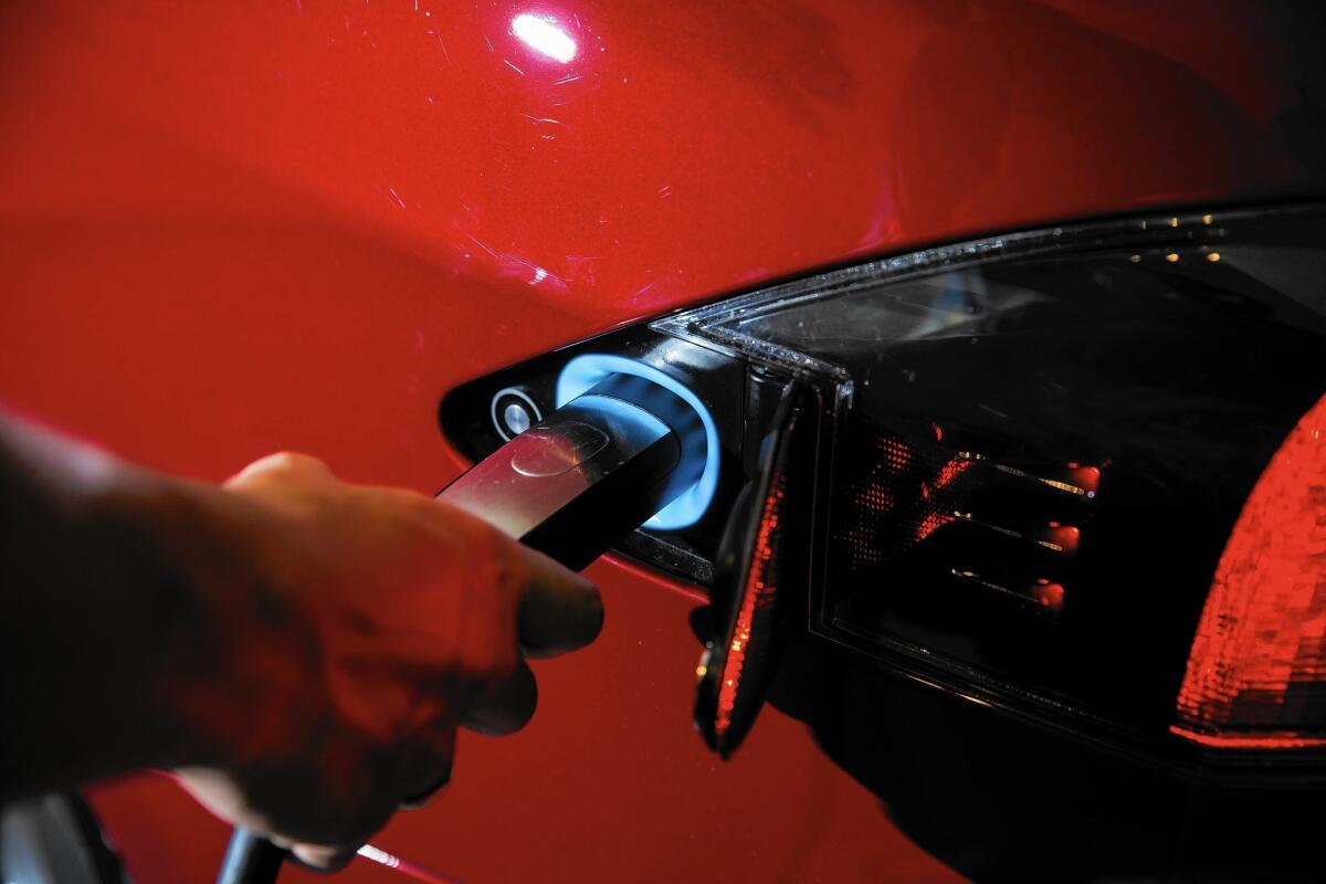 A Tesla Model S being charged in a Santa Monica showroom. The entry-level Tesla model starts at about $75,000.