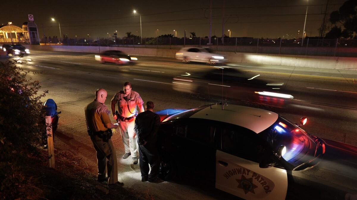 California Highway Patrol officers arrest a motorcyclist who led officers on a pursuit in Los Angeles on June 3, 2018.