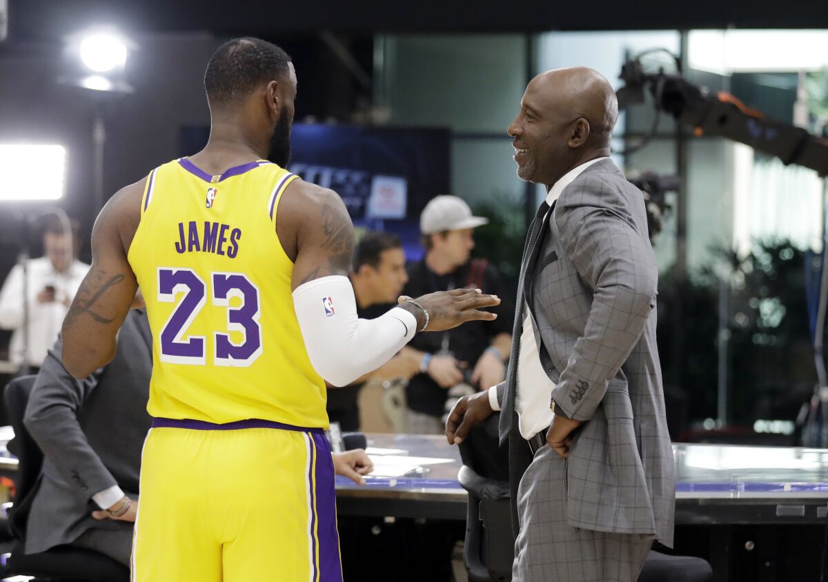 Lakers Hall of Famer James Worthy chats with LeBron James (23) at media day in 2018.