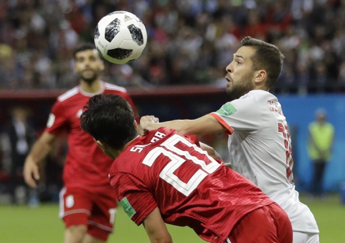 Spain's Jordi Alba, right, vies for the ball with Iran's Sardar Azmoun during a Group B match on June 20.