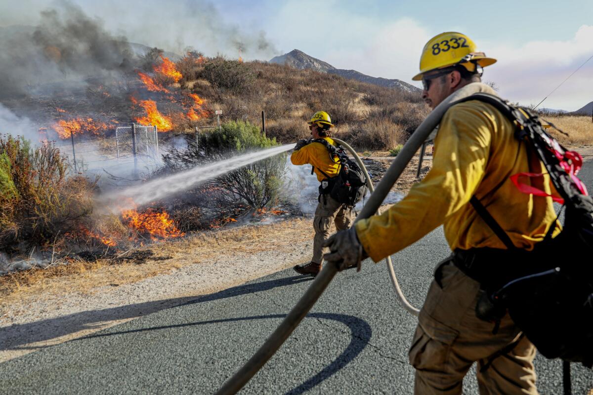 CalFire crews battle a wildfire along Barrett Junction Rd on San Diego on Wednesday, August 31, 2022