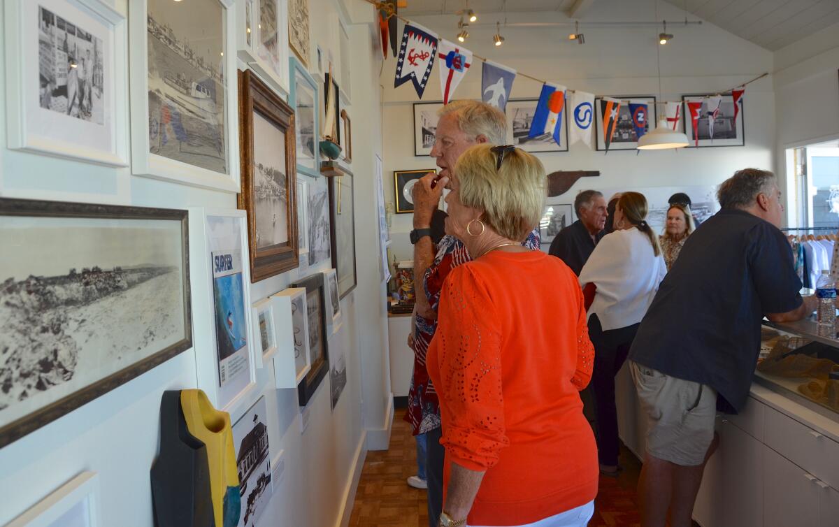 John Vallely studies a historical photo with his wife, Karen.