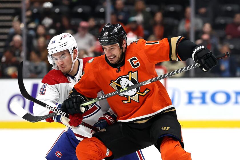 ANAHEIM, CALIFORNIA - OCTOBER 31: Ryan Getzlaf #15 of the Anaheim Ducks battles Nick Suzuki #14 of the Montreal Canadiens for a loose puck during the second period of a game at Honda Center on October 31, 2021 in Anaheim, California. (Photo by Sean M. Haffey/Getty Images)