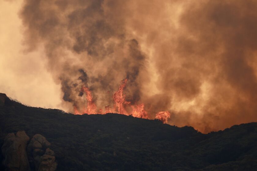 The Cave Fire continues to burn in the Santa Ynez Mountains above Santa Barbara Tuesday morning.