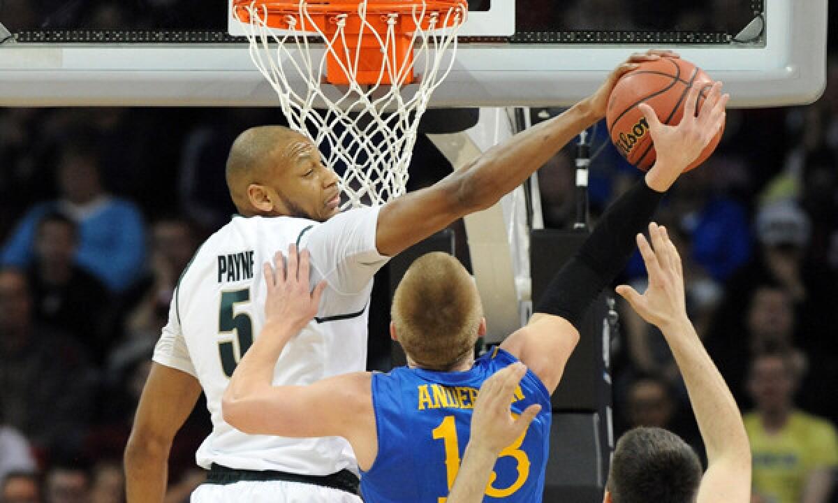 Michigan State's Adreian Payne blocks a shot by Delaware's Kyle Anderson during the Spartans' 93-78 win in the second round of the NCAA tournament on Thursday.