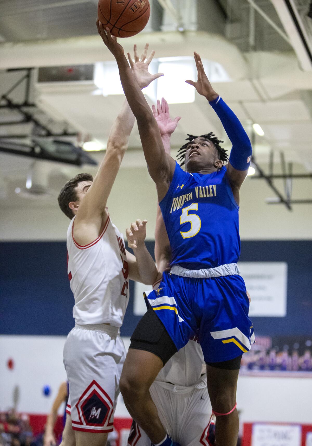 Fountain Valley's Jeremiah Davis (5) goes up for a shot against Yorba Linda's Alex Davis in the quarterfinals of the CIF Southern Section Division 3A playoffs on Tuesday.