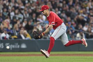 Los Angeles Angels shortstop Zach Neto mishandles the ball for a fielding error.