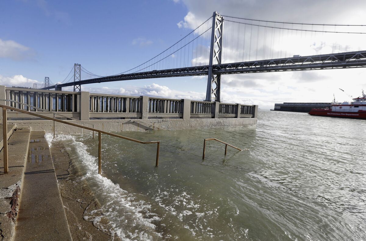 High tide floods a staircase along the Embarcadero in San Francisco 