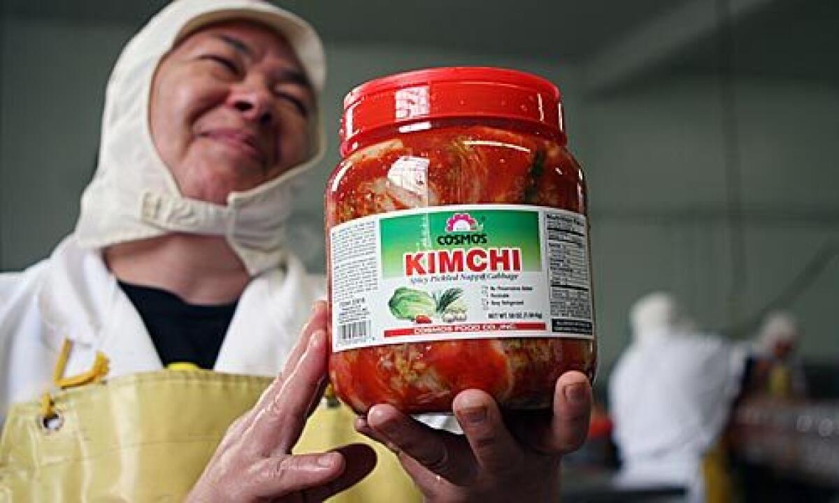 ALL DONE: Factory manager Teresa Guerrero displays a jar of the finished product.