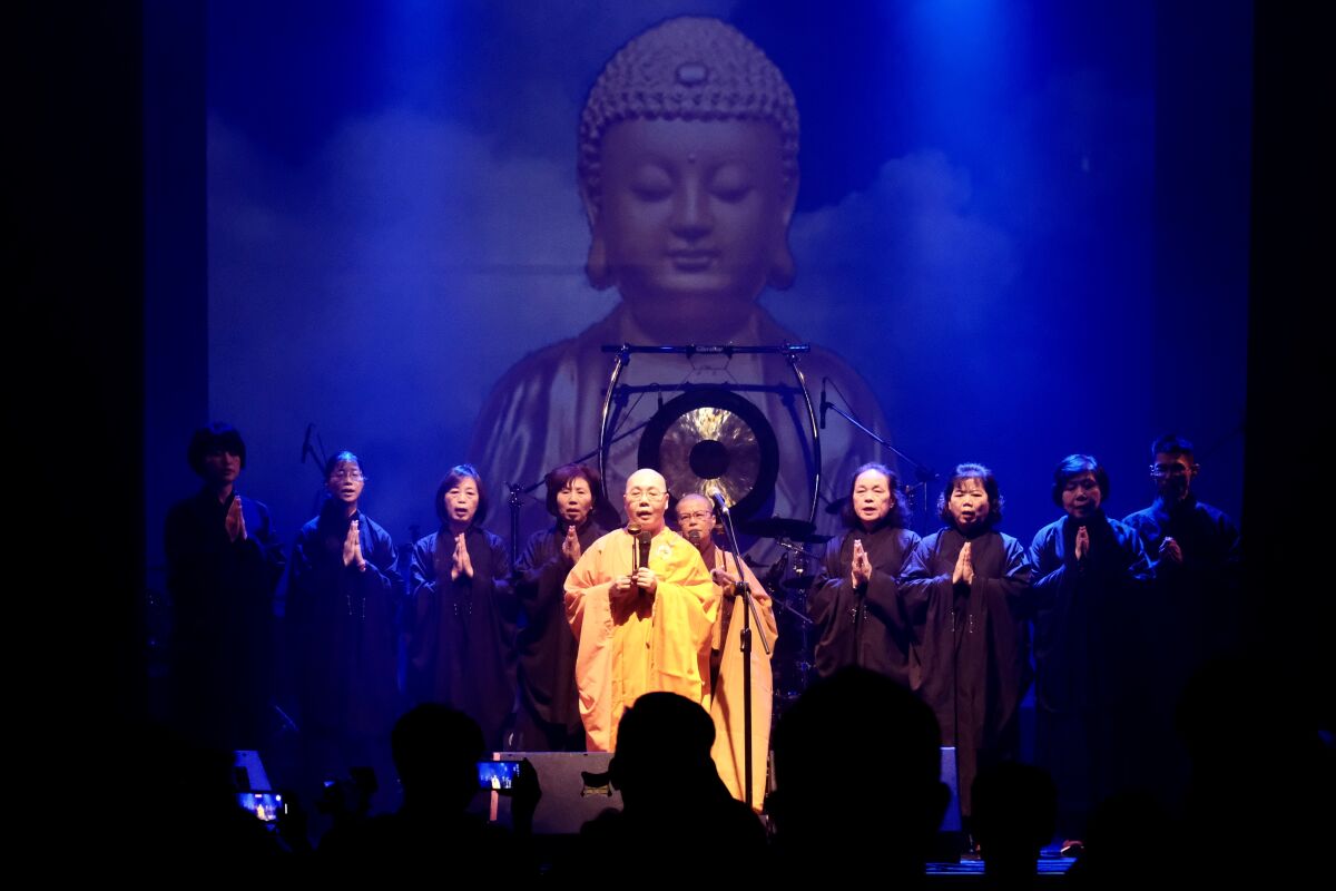 Buddhist nun Miao Ben, center, a vocalist with Taiwanese death metal band Dharma, performs during a concert in Taichung.