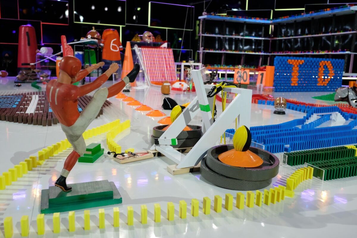 a football player figure surrounded by dominoes