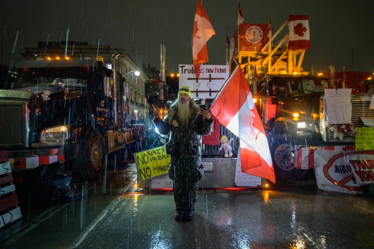 Canadian truck protestor standing in rain. 