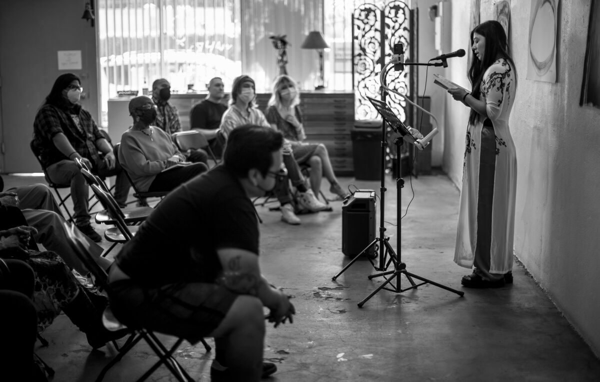 A black-and-white photo of a poetry reading.