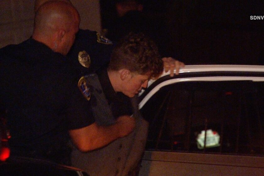 Police arrest a man in front of a Del Cerro home where two women were held hostage.