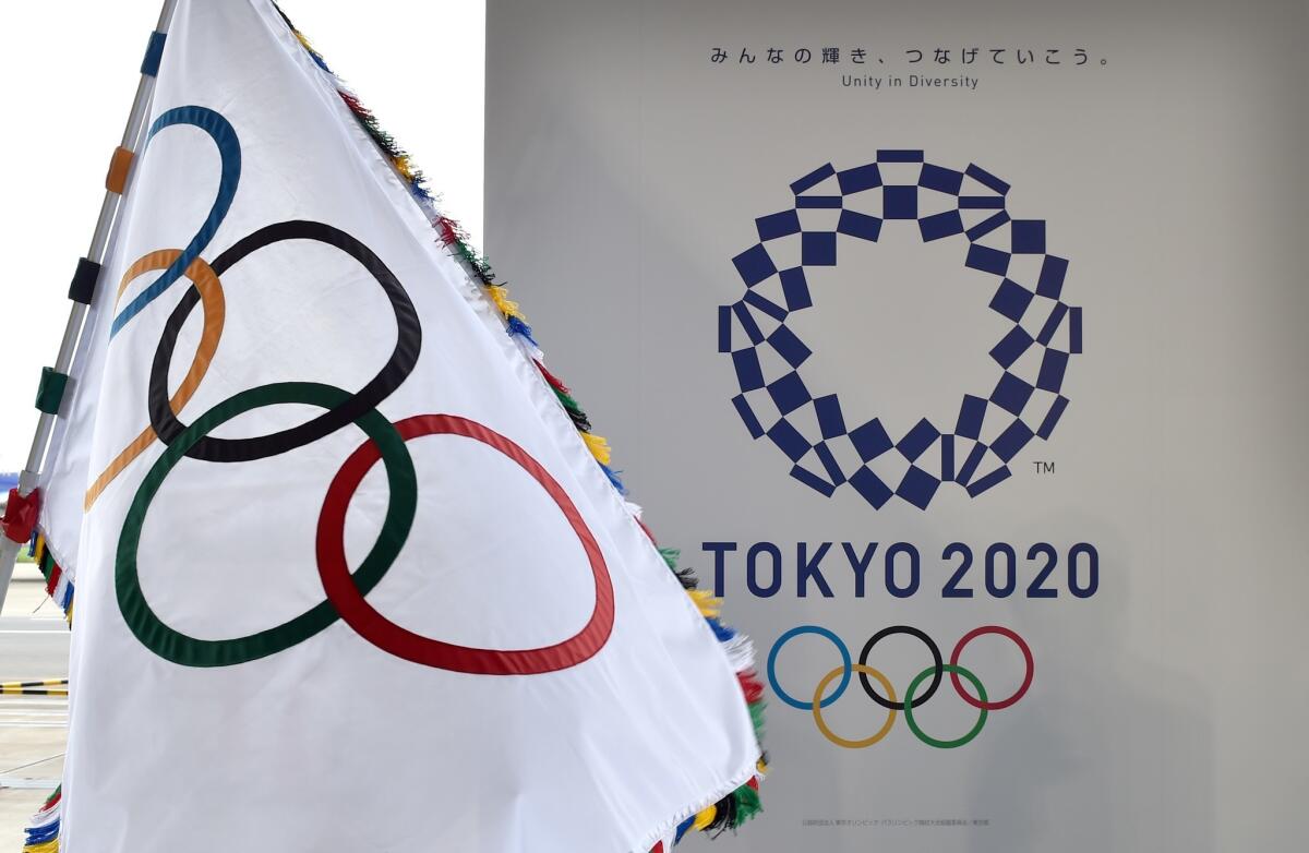 The Olympic flag and the logo of Tokyo 2020 are at Haneda airport on Aug. 24.