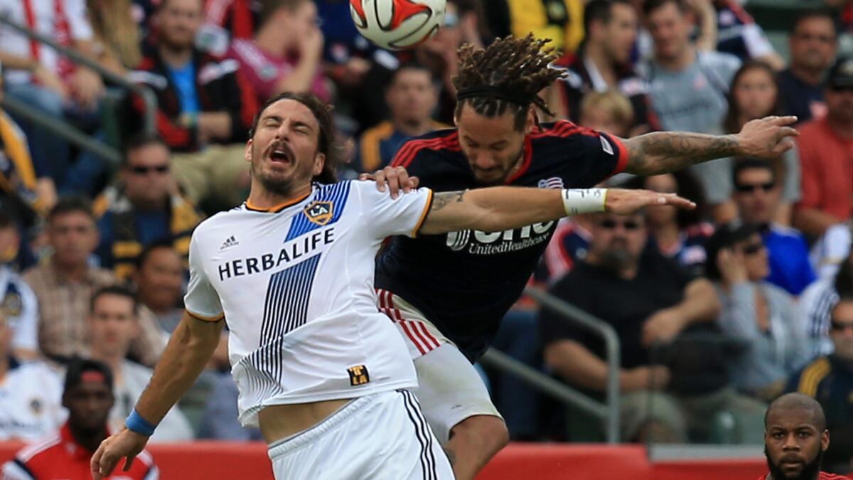 Galaxy forward Alan Gordon, left, and New England Revolution midfielder Jermaine Jones battle for a header during the Galaxy's 2-1 overtime win Sunday in the MLS Cup final at StubHub Center in Carson.
