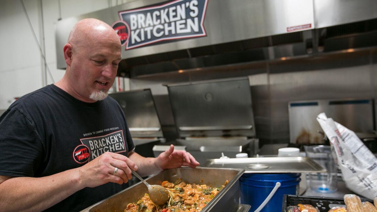 Bill Bracken, founder of Bracken's Kitchen, a nonprofit that feeds impoverished people, prepares meals at Hana Kitchens in Huntington Beach on Sept. 5.