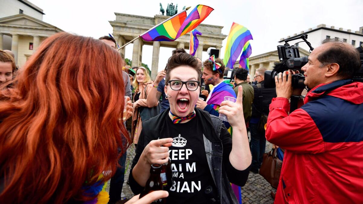 People celebrate at a rally in front of the Brandenburg Gate in Berlin.