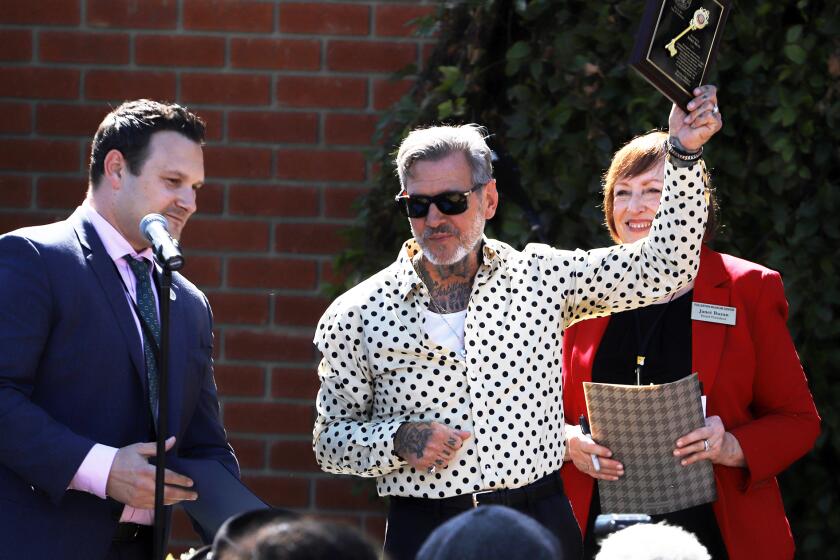 Mike Ness the leader singer of the legendary punk rock band Social Distortion is honored holds up the key of Fullerton and April 3 is declared Mike Ness day in Fullerton by the Mayor of Fullerton Nicholas Dunlap for his contribution to the city of Fullerton at the Fullerton Museum Center in Fullerton on Wednesday, April 3, 2024. (Photo by James Carbone)