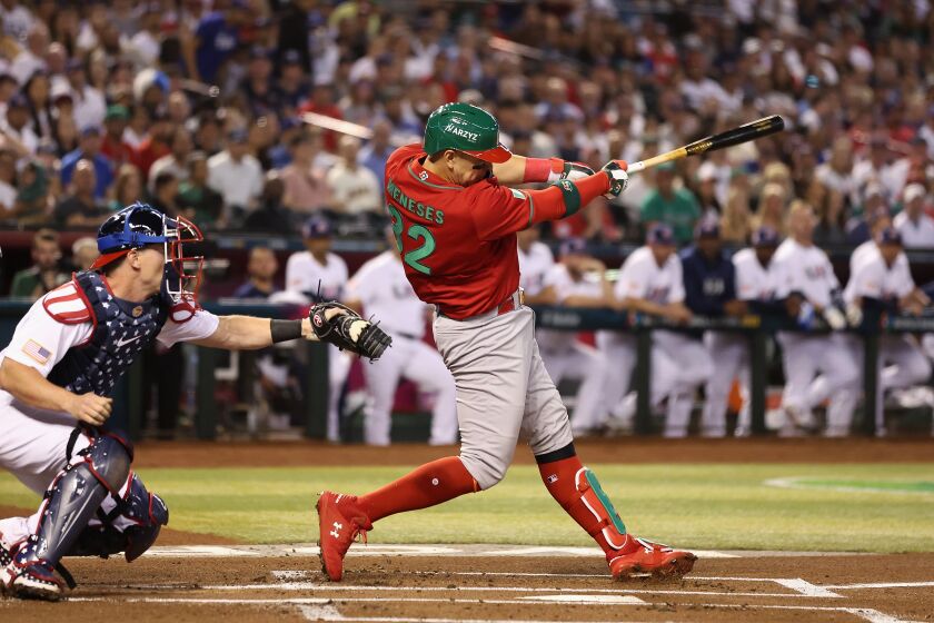 PHOENIX, ARIZONA - MARCH 12: Joey Meneses #32 of Team Mexico hits a two-run home run against Team USA during the first inning of the World Baseball Classic Pool C game at Chase Field on March 12, 2023 in Phoenix, Arizona. (Photo by Christian Petersen/Getty Images)