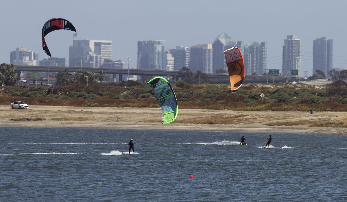 Kite surfers take advantage of an afternoon breeze and a sunny day at Fiesta Island.