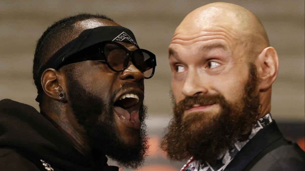 Deontay Wilder, left, and Tyson Fury exchange words at a news conference Nov. 28 in Los Angeles.