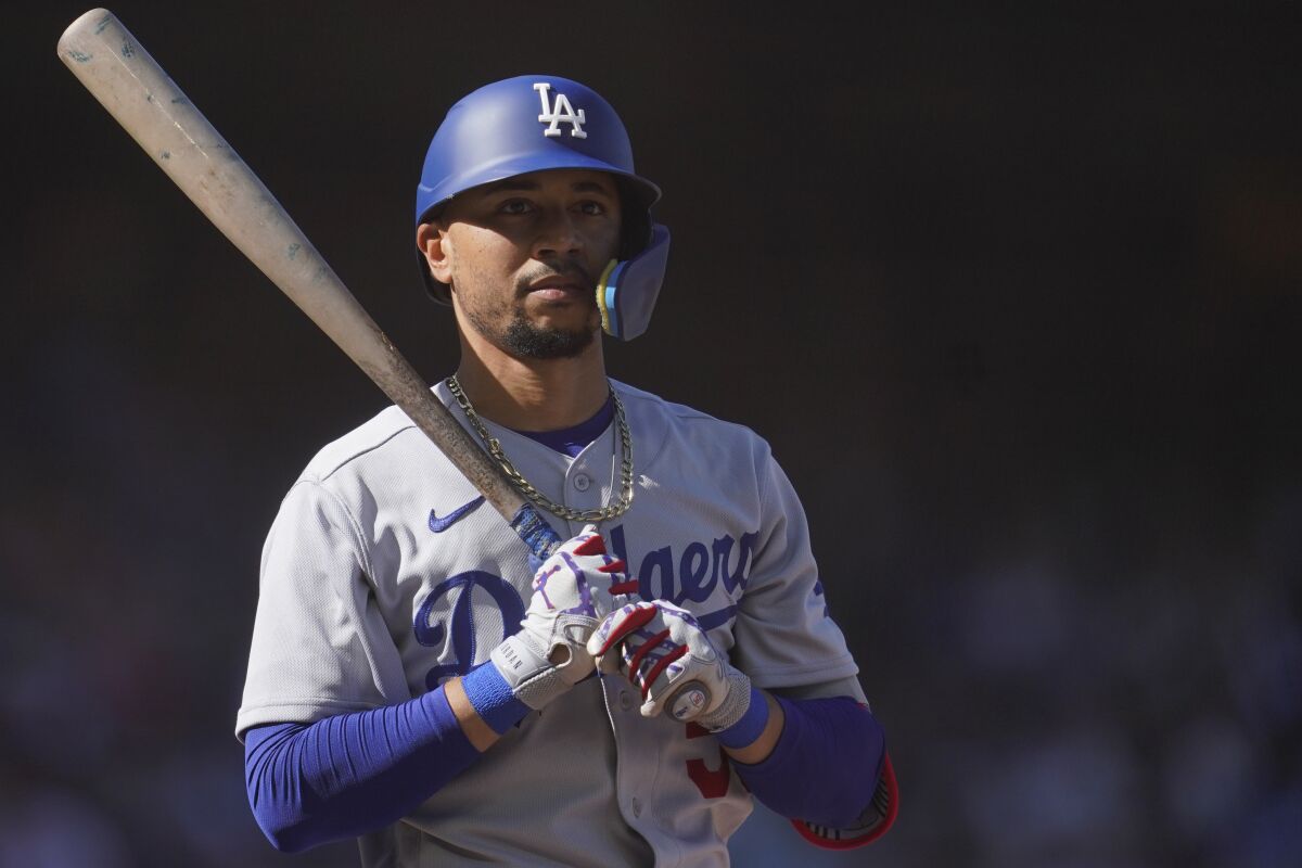 Dodgers star Mookie Betts prepares to bat against the Giants.