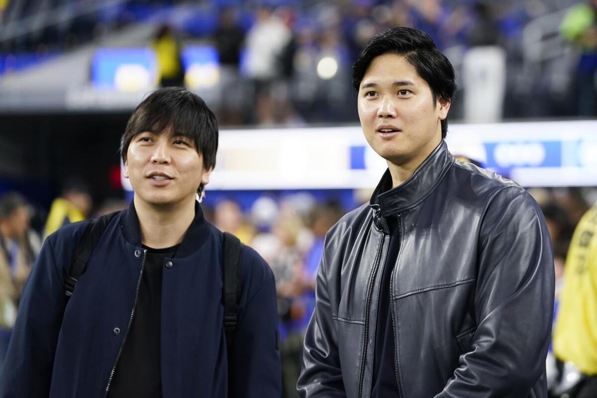 Shohei Ohtani, right, and his then-interpreter Ippei Mizuhara, attend a Rams game at SoFi Stadium.