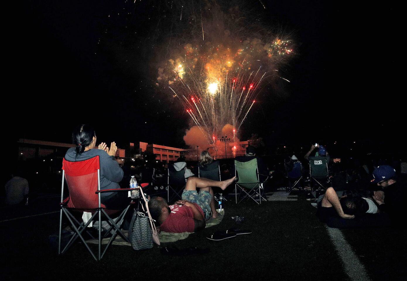 A small portion of the large crowd on the football field watching fireworks at the 14th annual Crescenta Valley Fireworks Association Fireworks Extravaganza at Crescenta Valley High School on Thursday, July 4, 2019. Food trucks, bouncy slides, games, live music, all followed by fireworks were there for the ears and the eyes.