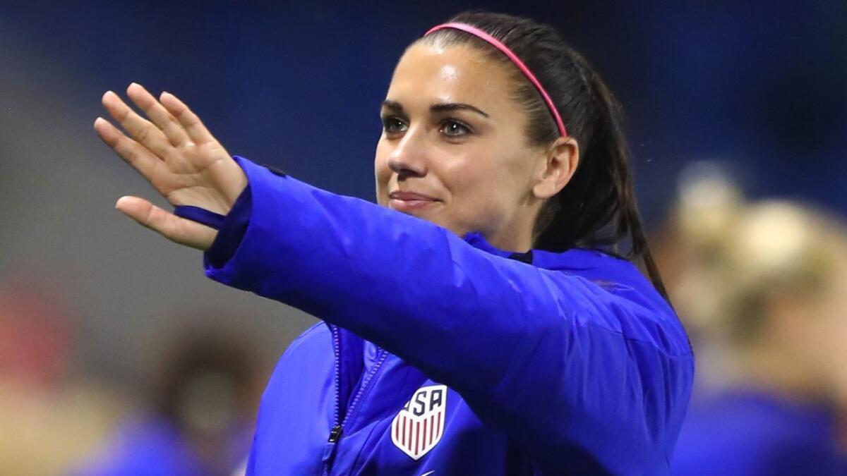 U.S. striker Alex Morgan waves to fans after a 2-0 Women's World Cup win over Sweden on June 20 in Le Havre, France.