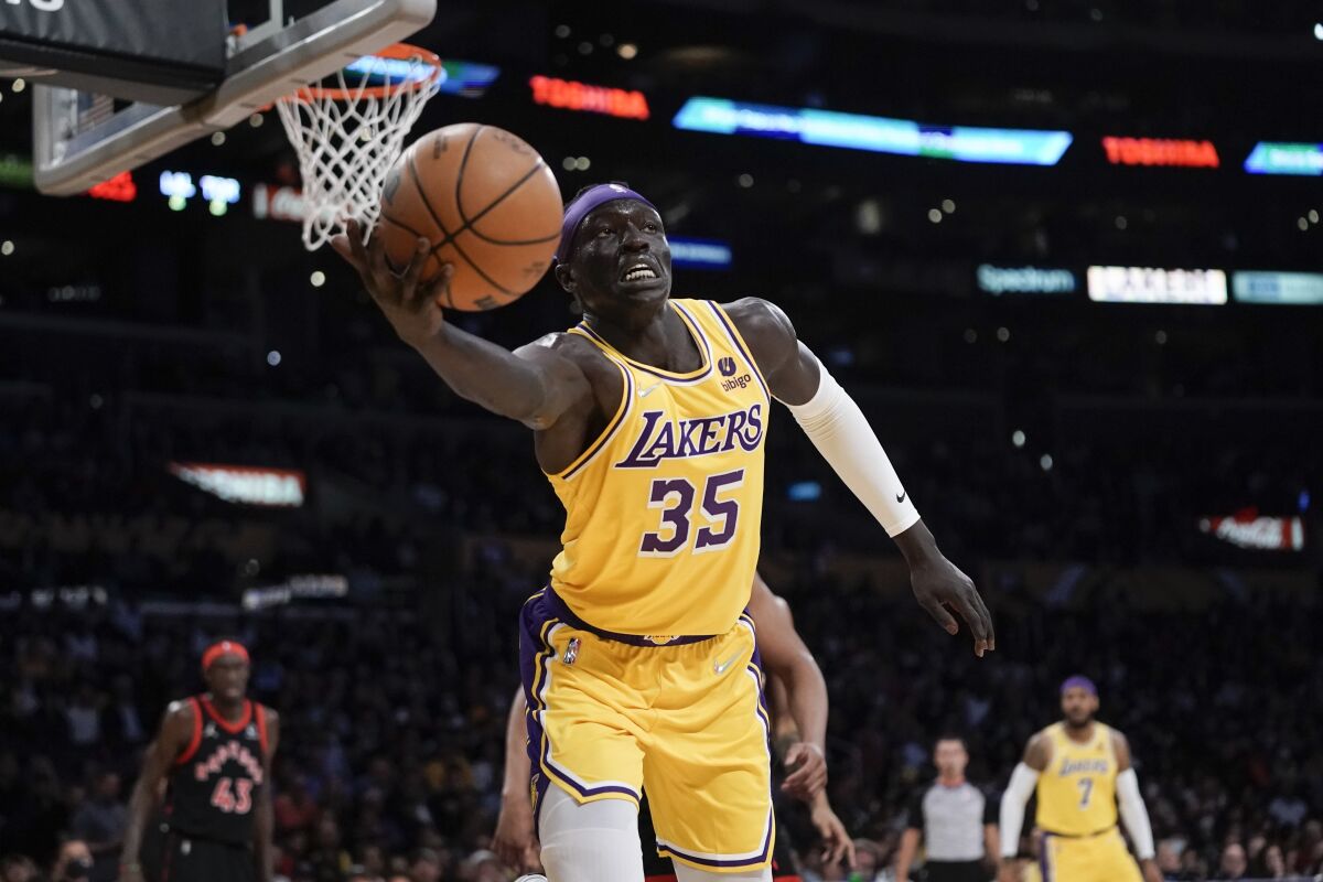 Lakers forward Wenyen Gabriel reaches for a loose ball during a game against the Raptors.
