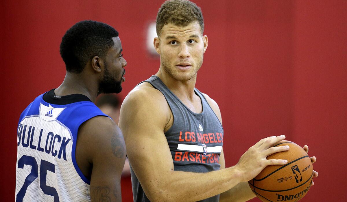 Clippers power forward Blake Griffin, right, talks with teammate Reggie Bullock during a training camp practice on Oct. 2 in Las Vegas.