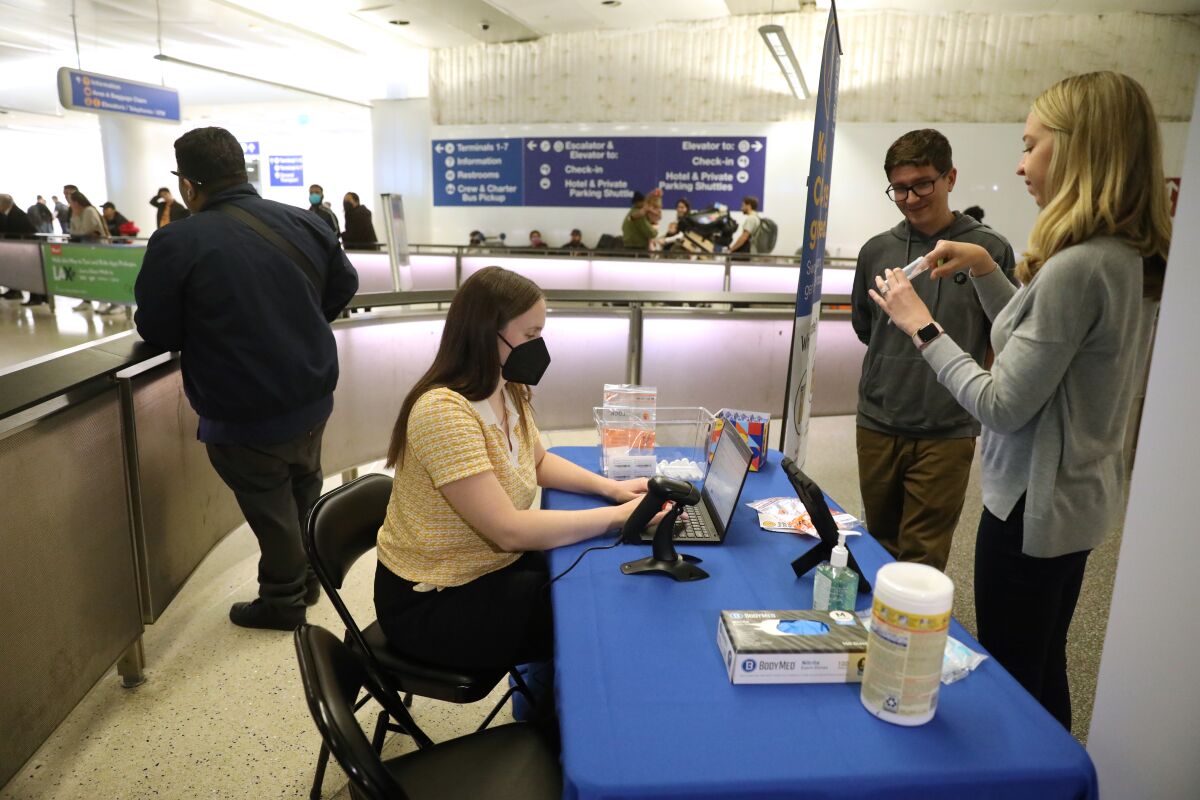 Claire Altieri works with colleagues Ryan Kramer and Amy Schierhorn to set up the new coronavirus testing site at LAX.