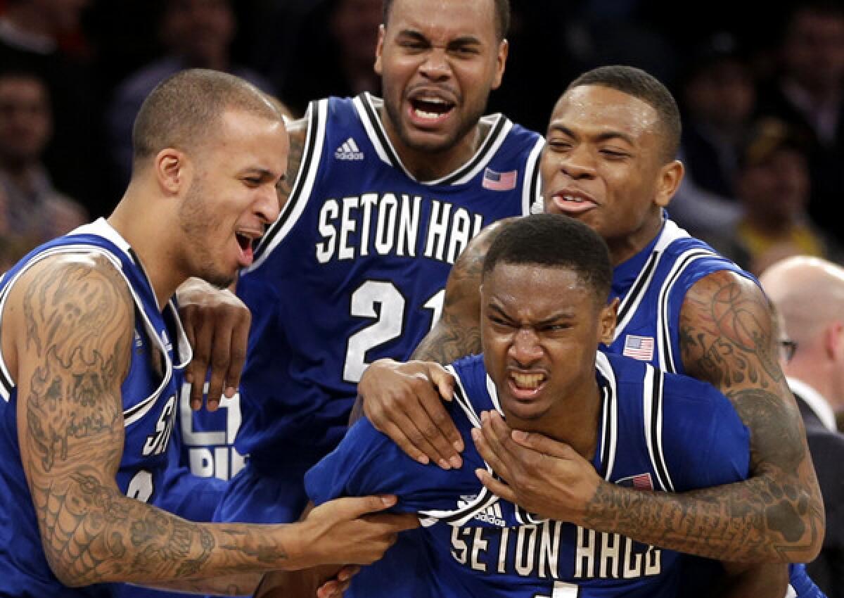 Teammates mob Seton Hall's Sterling Gibbs (4) after he hit the winning shot against Villanova in a Big East Conference tournament game at Madison Square Garden on Thursday in New York.