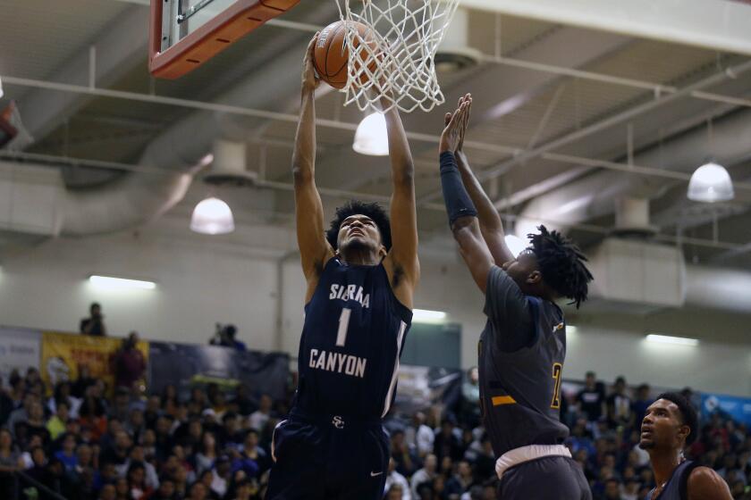 PASADENA, CALIF. -- SATURDAY, JANUARY 11, 2020: Ziaire Williams (1), of Sierra Canyon, slam dunks the ball in front of Dominick Harris (2), of Rancho Christian, in the Elite Invitational Basketball Tournament at Pasadena Community College in Pasadena, Calif., on Jan. 11, 2020. (Gary Coronado / Los Angeles Times)