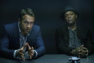This image released by Lionsgate shows Ryan Reynolds, left, and Samuel L. Jackson in a scene from "The Hitman's Wife's Bodyguard." “The Hitman’s Wife’s Bodyguard” strikes the top box office target. The Lionsgate’s film starring Ryan Reynolds, Samuel L. Jackson and Salma Hayek brought in $11.6 million domestically to claim the No. 1 spot in its debut. (David Appleby/Lionsgate via AP)