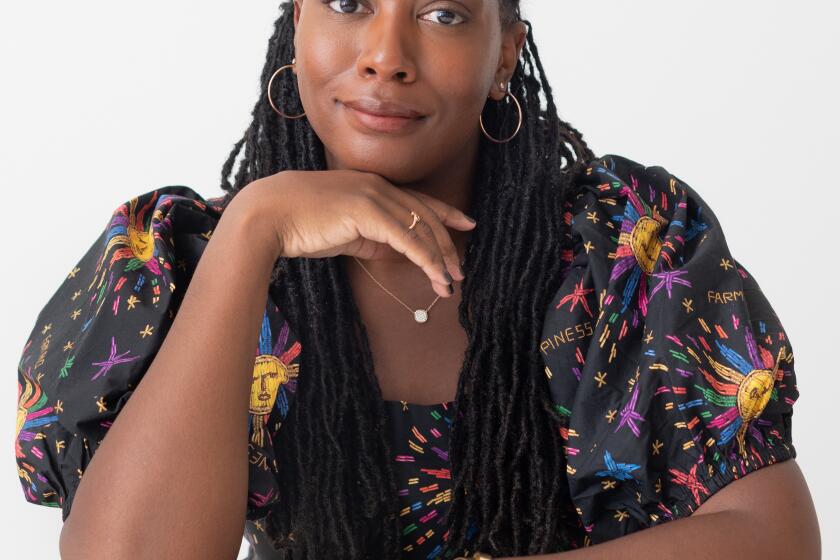 Portrait of Sarai Johnson seated and smiling at camera 