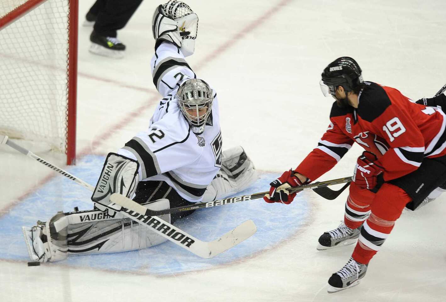 Kings goaltender Jonathan Quick makes a save on a shot by Devils center Travis Zajac in the second period of Game 5 on Saturday night in New Jersey.