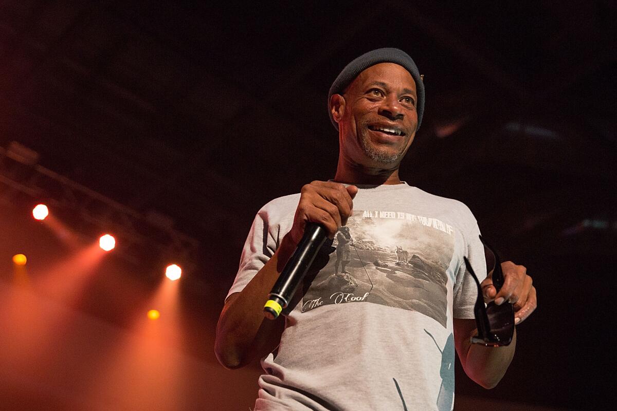 Brother Marquis of 2 Live Crew smiles onstage in a T-shirt and knit cap.