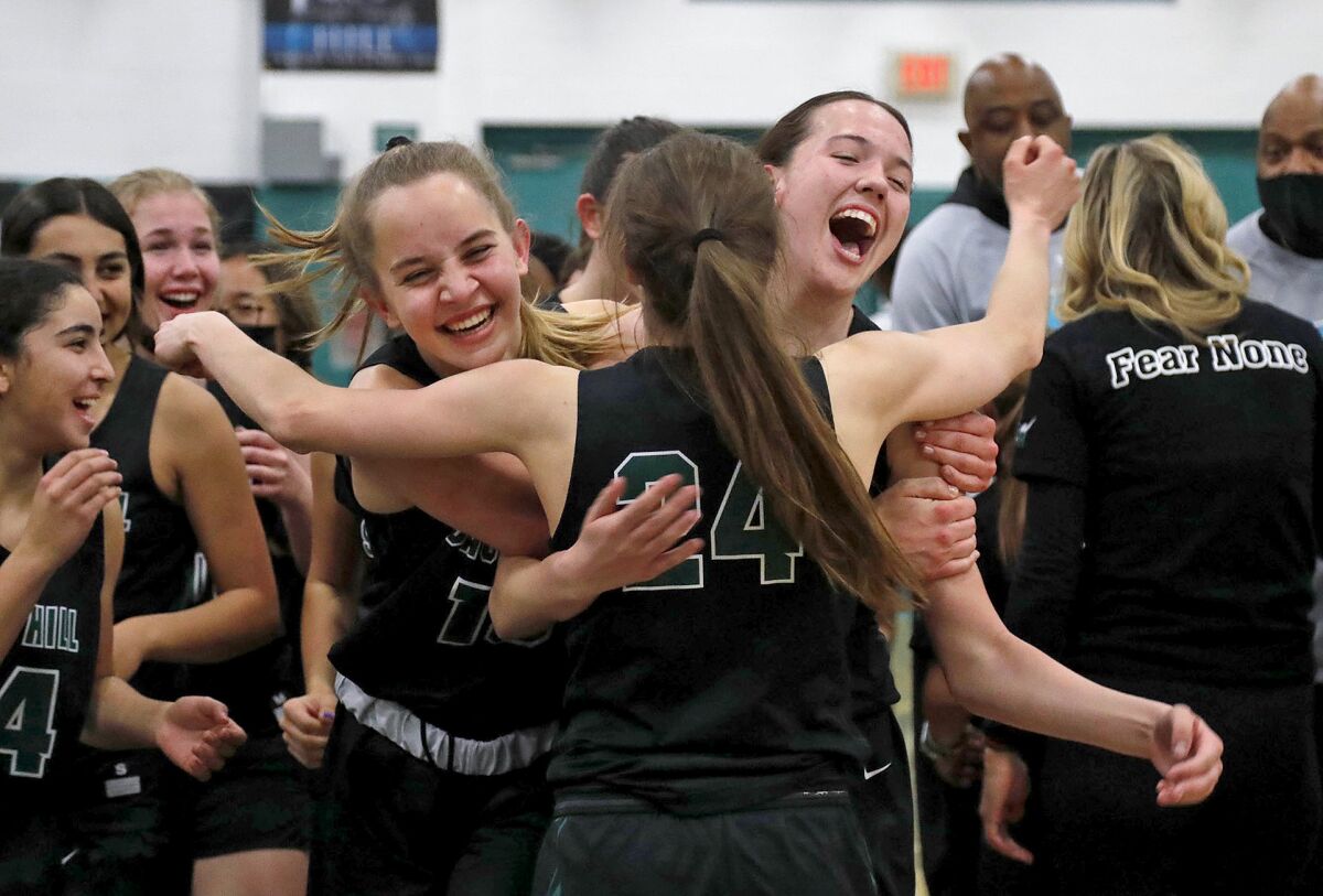 Sage Hill's Annabelle Spotts, left, and Kat Righeimer, right, embrace Isabel Gomez (24).